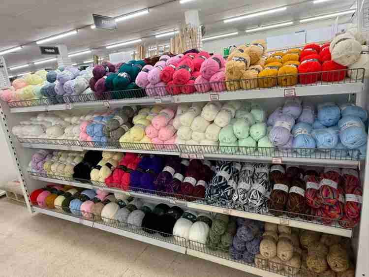 Colourful wool and sewing supplies displayed on shelves